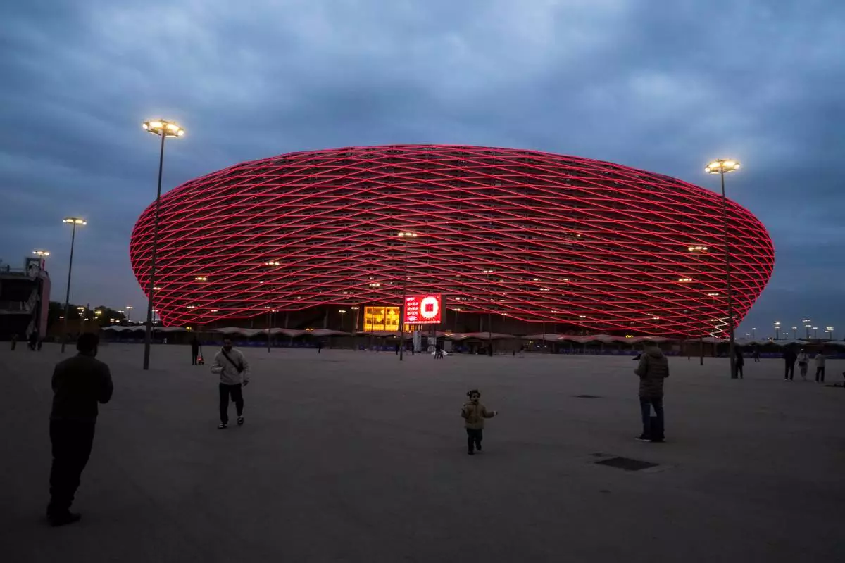 People take photos outside Prince Moulay Abdellah Stadium, which will host the opening and final game of the Africa Cup of Nations soccer competition, in Rabat, Morocco, Friday, Dec. 19, 2025. (AP Photo/Mosa'ab Elshamy)