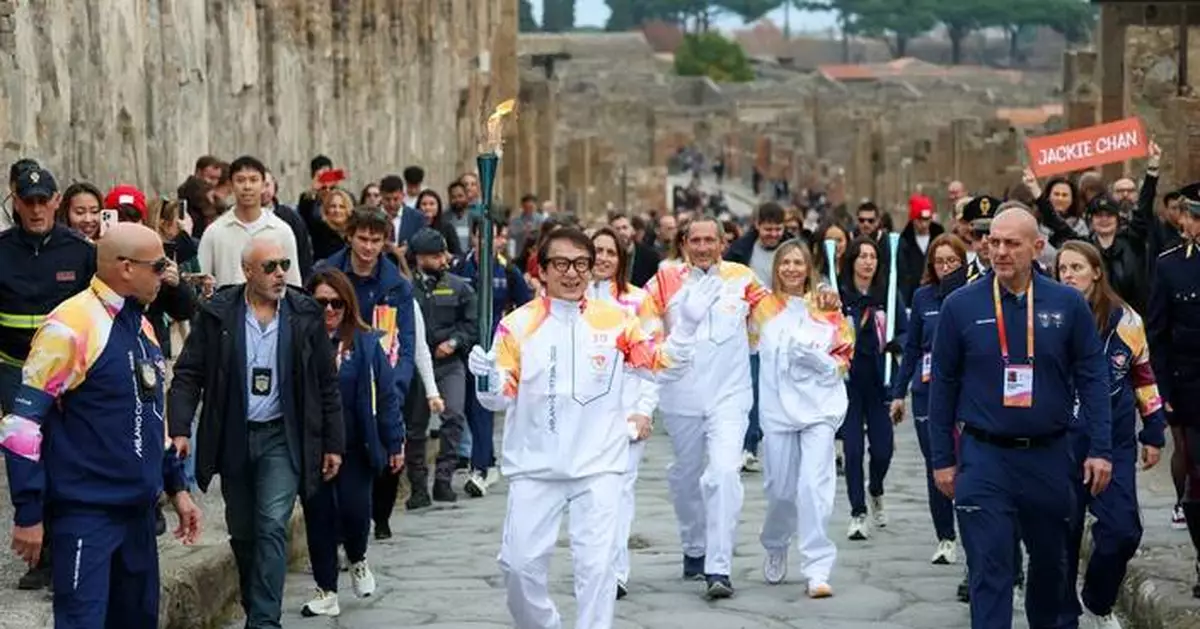 Jackie Chan carries the Milan Cortina Olympic torch through the ruins of Pompeii