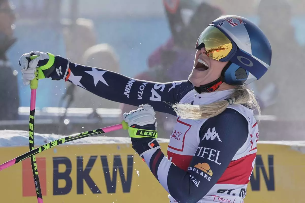 United States' Lindsey Vonn celebrates at the finish area of an alpine ski, women's World Cup downhill in St. Moritz, Switzerland, Friday Dec.12, 2025. (AP Photo/Luciano Bisi)