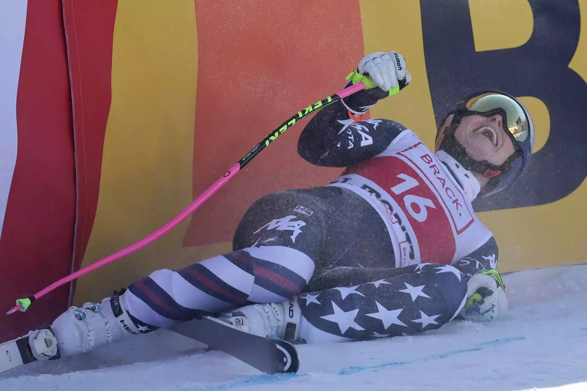 United States' Lindsey Vonn celebrates at the finish area of an alpine ski, women's World Cup downhill in St. Moritz, Switzerland, Friday, Dec.12, 2025. (AP Photo/Luciano Bisi)