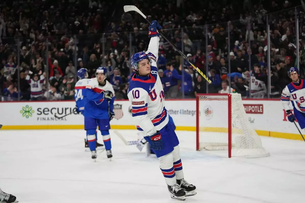 United States forward James Hagens (10) celebrates after scoring during the second period of an IIHF World Junior Hockey championship game against Slovakia, Monday, Dec. 29, 2025, in St. Paul, Minn. (AP Photo/Abbie Parr)