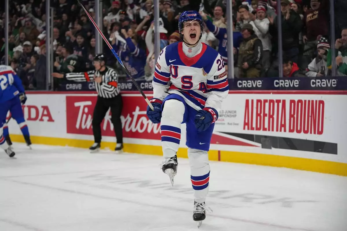 United States forward Brendan McMorrow (22) celebrates after scoring during the second period of an IIHF World Junior Hockey championship game against Slovakia, Monday, Dec. 29, 2025, in St. Paul, Minn. (AP Photo/Abbie Parr)