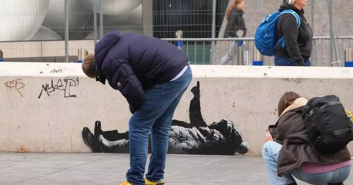 Banksy unveils new art in London following speculation over murals depicting stargazing figures