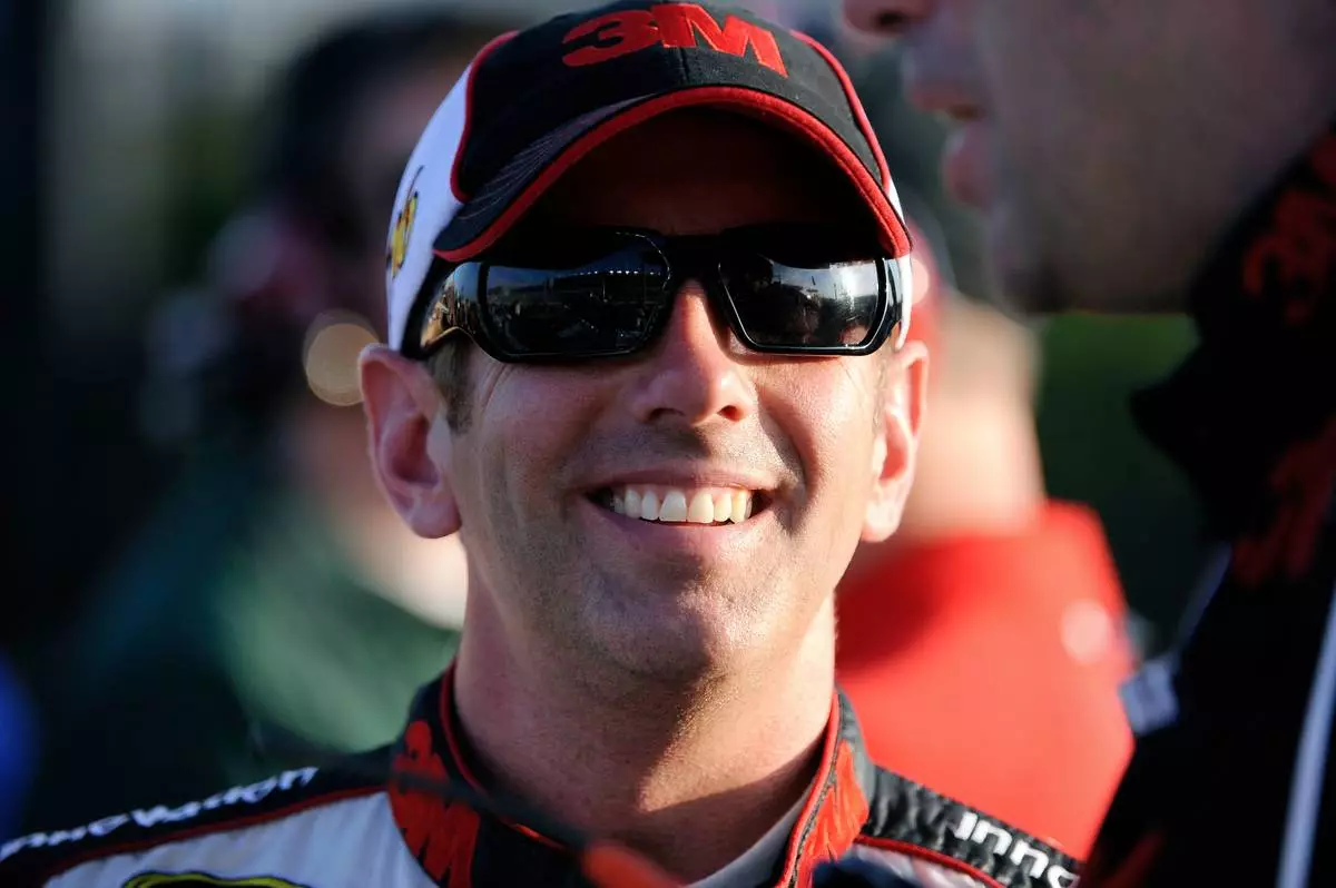 FILE - Greg Biffle smiles along pit row during qualifying for Sunday's NASCAR Sprint Cup Series auto race at Atlanta Motor Speedway, Friday, Aug. 31, 2012, in Hampton, Ga. (AP Photo/David Tulis, File)