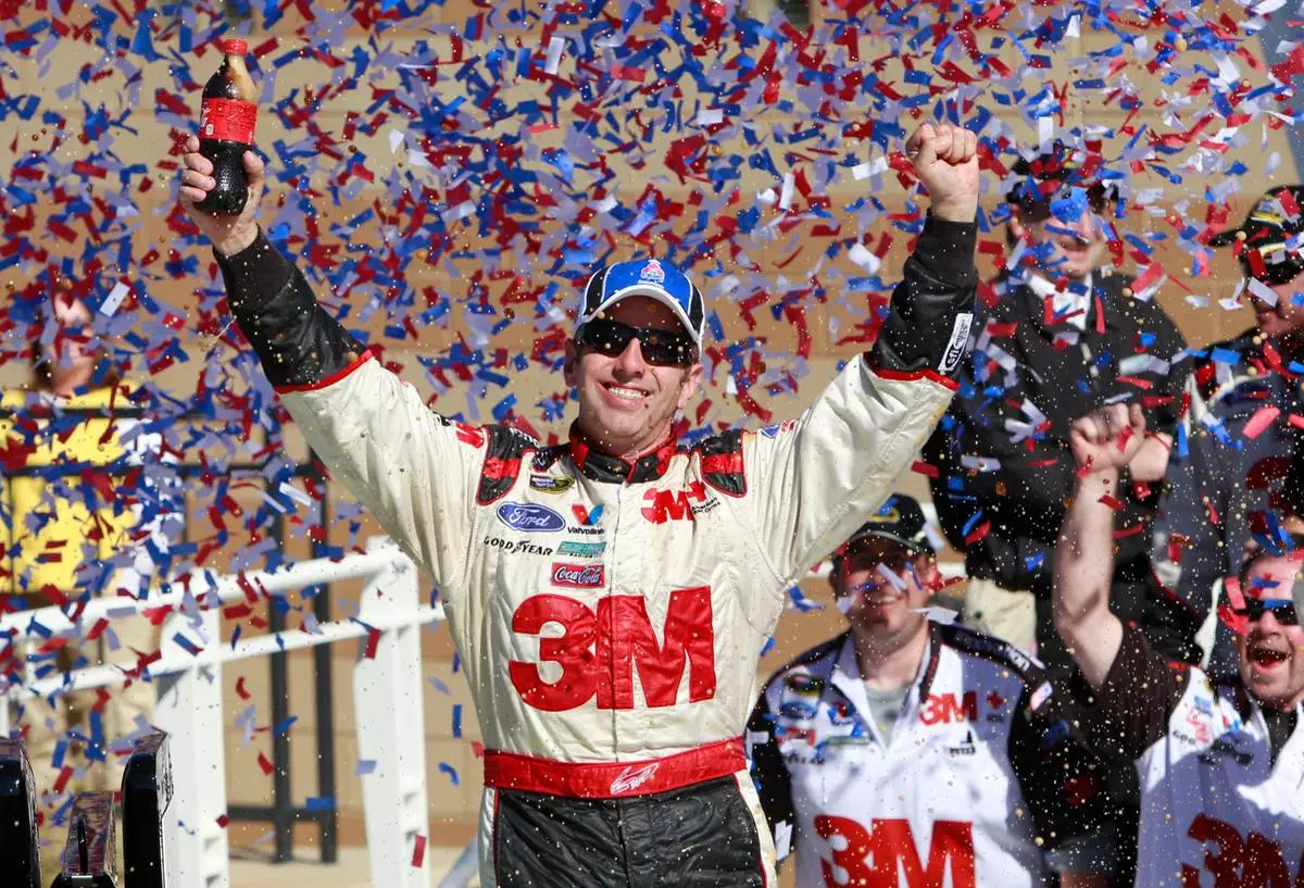 FILE - Greg Biffle celebrates in victory lane after winning the NASCAR Sprint Cup Series auto race at Kansas Speedway on Sunday, Oct. 3, 2010, in Kansas City, Kan. (AP Photo/Orlin Wagner, File)