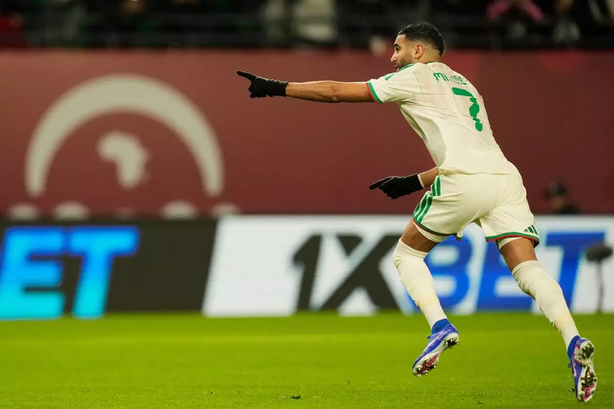 Algeria's Riyad Karim Mahrez celebrates after scoring his side's first goal during the Africa Cup of Nations group E soccer match between Algeria and Burkina Faso in Fez, Morocco, Sunday, Dec. 28, 2025. (AP Photo/Mosa'ab Elshamy)