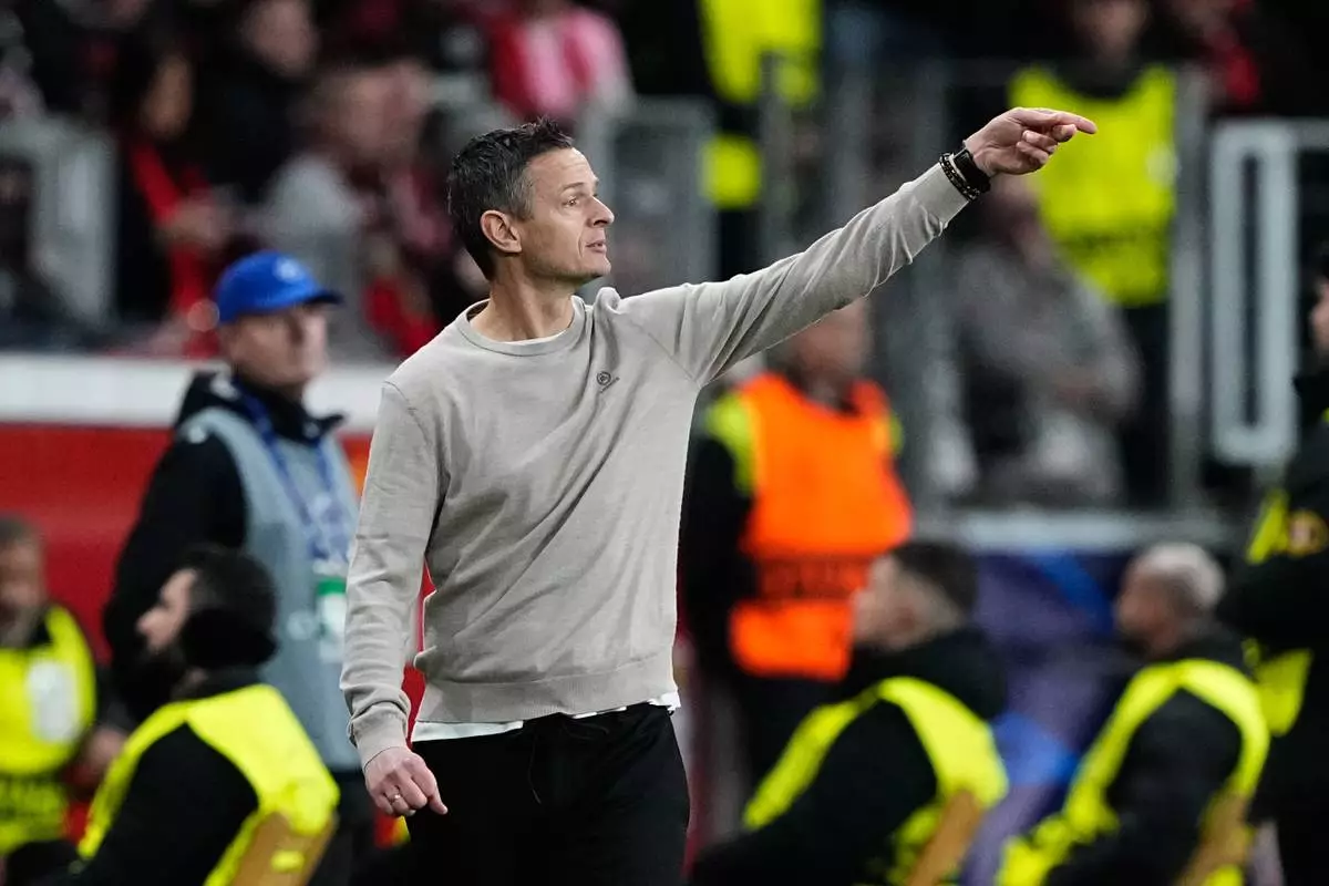 CORRECTS SPELLING OF FIRST NAME TO ROGIER, NOT ROGER - Leverkusen's assistant coach Rogier Meijer gestures during the Champions League opening phase soccer match between Bayer Leverkusen and Newcastle United in Leverkusen, Germany, Wednesday, Dec. 10, 2025. (AP Photo/Martin Meissner)