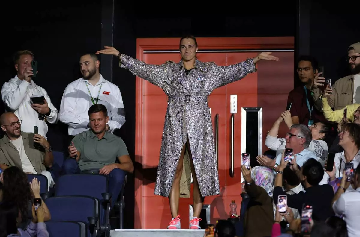 Aryna Sabalenka makes her way to the court for the Battle of the Sexes match between Aryna Sabalenka and Nick Kyrgios in Dubai, United Arab Emirates, Sunday Dec. 28, 2025. (Amr Alfiky/Pool Photo via AP)