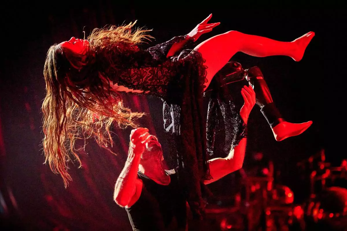 Volunteer soldier Rusya Danylkina, 21, who lost her leg in Russia-Ukraine war, and choreographer Pavlo Semakin perform during the shooting of the Christmas TV show ''Dancing with the Stars'' in Kyiv, Ukraine, Thursday, Dec. 18, 2025. (AP Photo/Efrem Lukatsky)