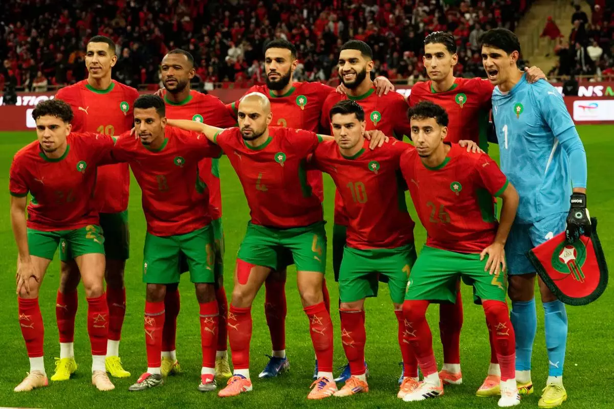 Morocco's starting team phone for photographers ahead of the African Cup of Nations Group A soccer match between Morocco and Mali in Rabat, Friday, Morocco 26, 2025. (AP Photo/Mosa'ab Elshamy)