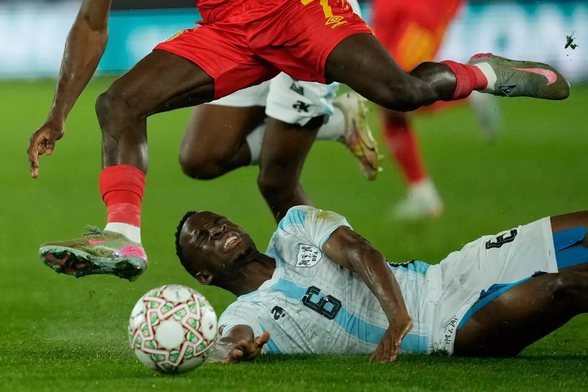 DR Congo's Nathanael Mbuku, top, and Botswana's Gape Edwin Mohutsiwa challenge for the ball during their teams' Africa Cup of Nations group D soccer match in Rabat, Morocco, Tuesday, Dec. 30, 2025. (AP Photo/Mosa'ab Elshamy)