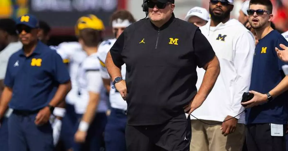 Biff Poggi tells signees and parents Michigan hopes to hire a coach by end of month, AP source says