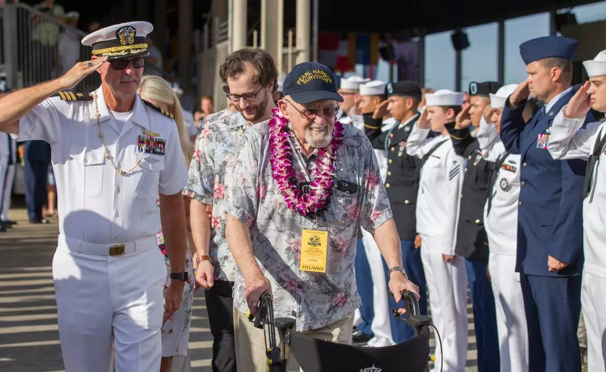 FILE - Pearl Harbor survivor Ira Schab, right, is saluted by various members of the armed forces as he leaves the 75th Anniversary National Pearl Harbor Remembrance Day Commemoration on Kilo Pier at Joint Base Pearl Harbor-Hickam, Wednesday, Dec. 7, 2016, in Honolulu. (AP Photo/Eugene Tanner, File)