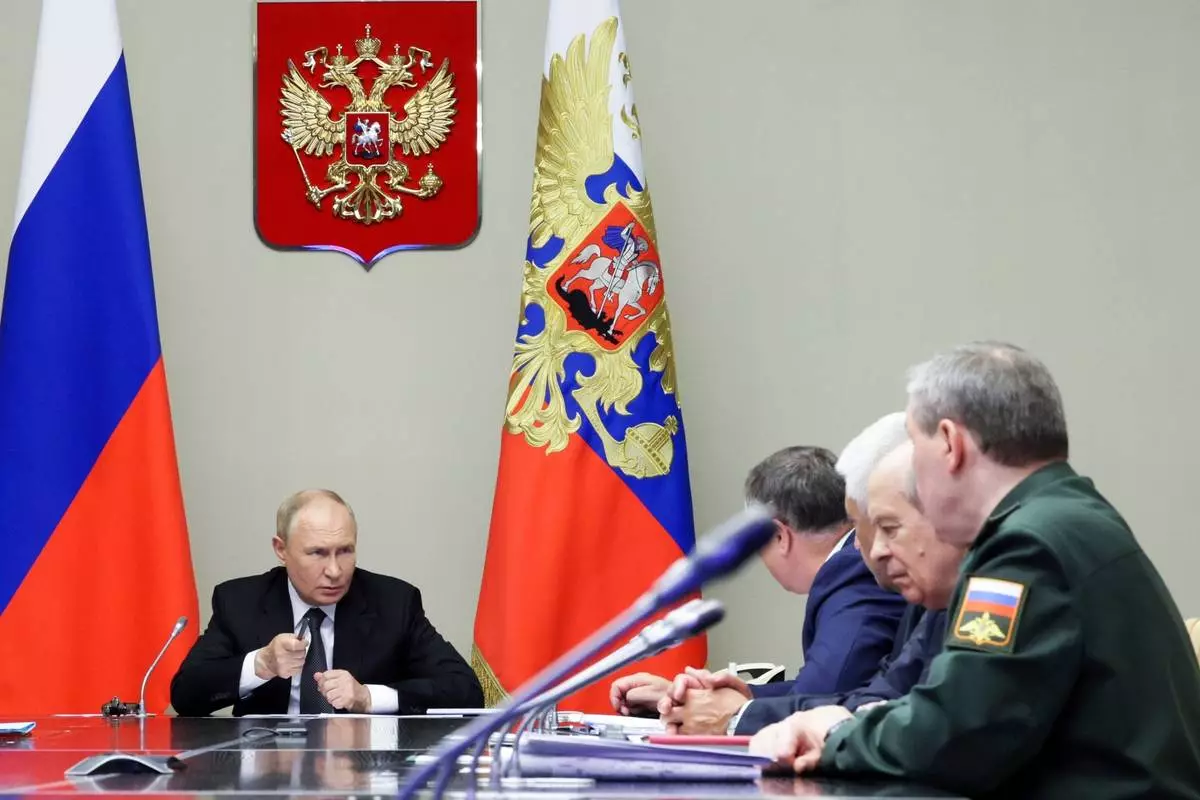 FILE - Russian President Vladimir Putin, left, leads a meeting with top security and defense officials at the Novo-Ogaryovo state residence outside of Moscow, Aug. 12, 2024. (Gavriil Grigorov, Sputnik, Kremlin Pool Photo via AP, File)