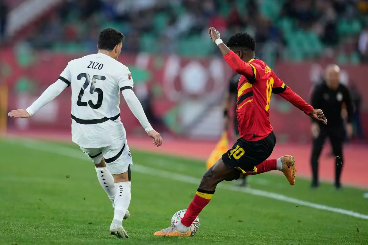Angola's Gelson Dala, right, kicks the ball during the Africa Cup of Nations group B soccer match between Angola and Egypt in Agadir, Morocco, Monday, Dec. 29, 2025. (AP Photo/Mosa'ab Elshamy)