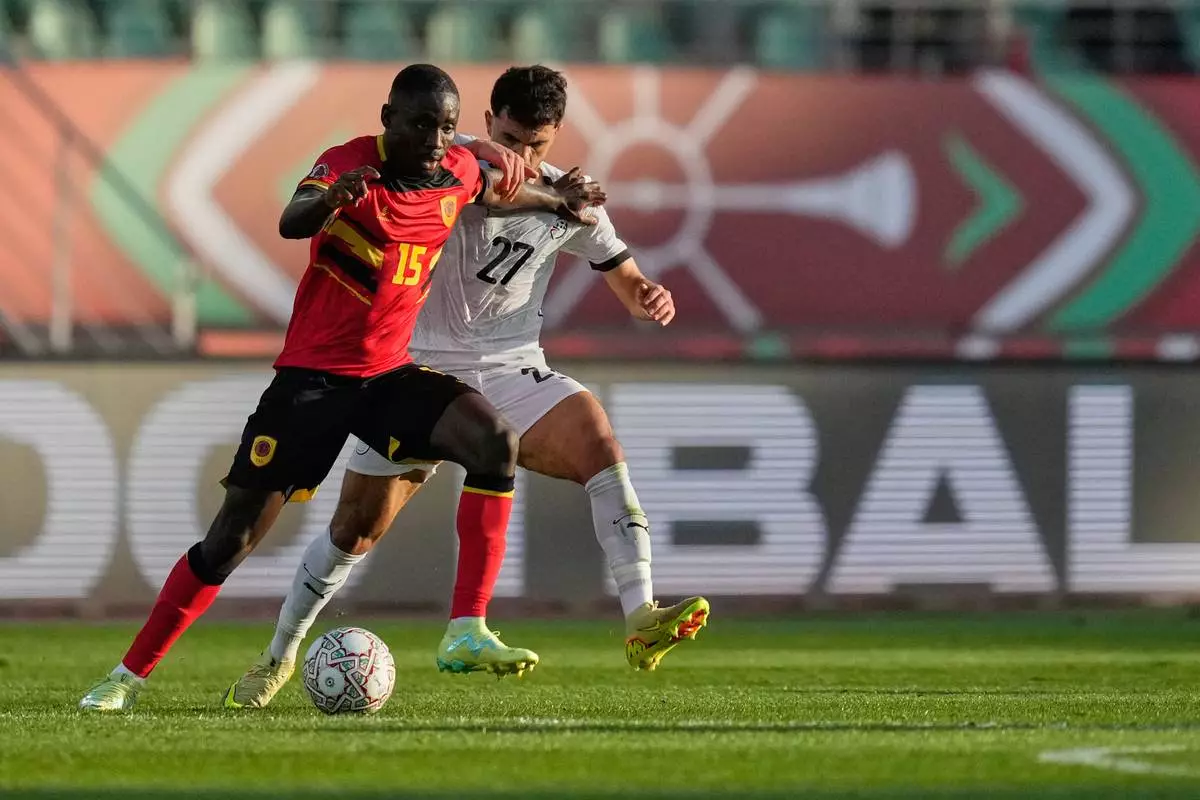Angola's Beni Mukendi and Egypt's Mahmoud Saber compete for the ball during the Africa Cup of Nations group B soccer match between Angola and Egypt in Agadir, Morocco, Monday, Dec. 29, 2025. (AP Photo/Mosa'ab Elshamy)