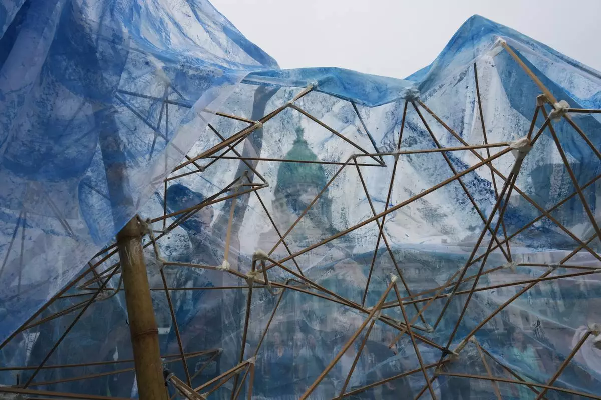 FILE - Environmental activists assemble a glacier-shaped structure of fabric and sticks during a protest opposing a bill to ease environmental protections, outside Congress in Buenos Aires, Argentina, Monday, Dec. 22, 2025. (AP Photo/Rodrigo Abd, File)