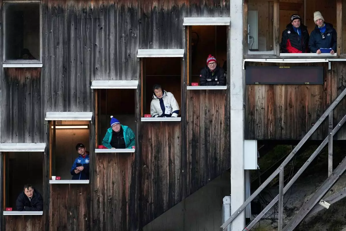 FILE - Judges watch from their windows during the men's Individual Gundersen Normal Hill/10Km event, at the Nordic Combined World Cup in Ramsau am Dachstein, Austria, Saturday, Dec. 20, 2025. (AP Photo/Matthias Schrader, File)