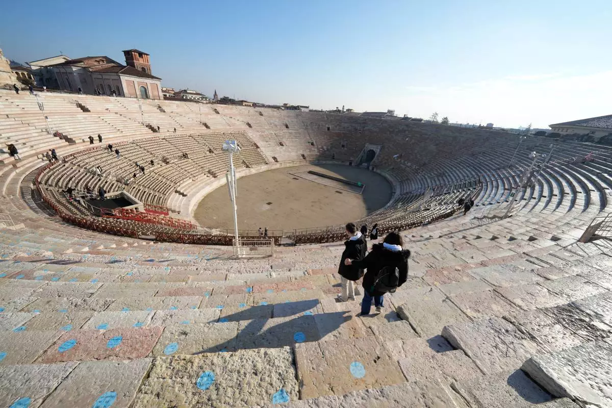 Visitors climb down at the Arena of Verona, Italy, Wednesday, Dec. 10, 2025. (AP Photo/Luca Bruno)