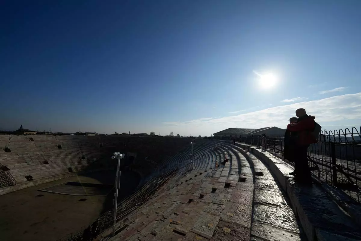 Visitors watch from the last ring at the Arena of Verona, Italy, Wednesday, Dec. 10, 2025. (AP Photo/Luca Bruno)