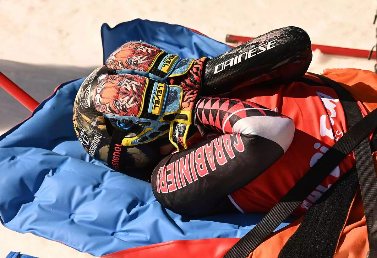 FILE - Overall World Cup skiing champion Italy's Federica Brignone is carried away on a toboga after she broke multiple bones in her left leg during a giant slalom crash at the Italian championships in the Lusia ski area, in Val di Fassa, Italy, Thursday, April 3, 2025. (AP Photo/Elvis Piazzi, file)