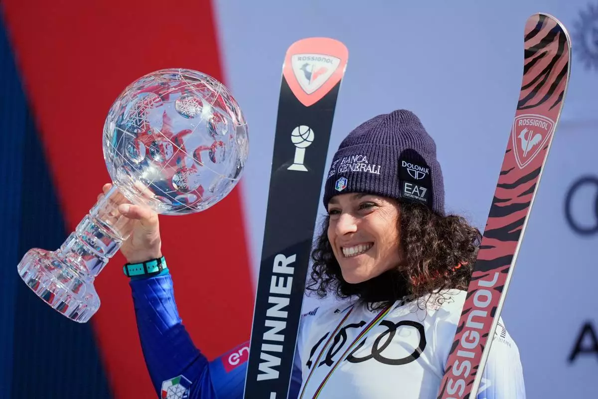FILE - Italy's Federica Brignone reacts on the podium after winning the women's World Cup overall at the World Cup Finals, Thursday, March 27, 2025, in Sun Valley, Idaho. (AP Photo/Robert F. Bukaty, file)