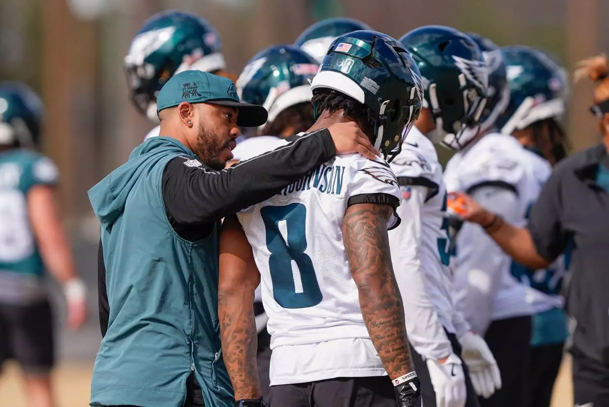 FILE - Philadelphia Eagles secondary coach Christian Parker talks with safety C.J. Gardner-Johnson (8) during an NFL football practice, Feb. 5, 2025, in New Orleans. (AP Photo/Gerald Herbert, File)
