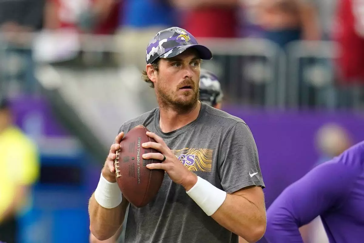 FILE - Minnesota Vikings quarterback Sean Mannion warms up before a preseason NFL football game against the San Francisco 49ers, Aug. 20, 2022, in Minneapolis. (AP Photo/Abbie Parr, File)