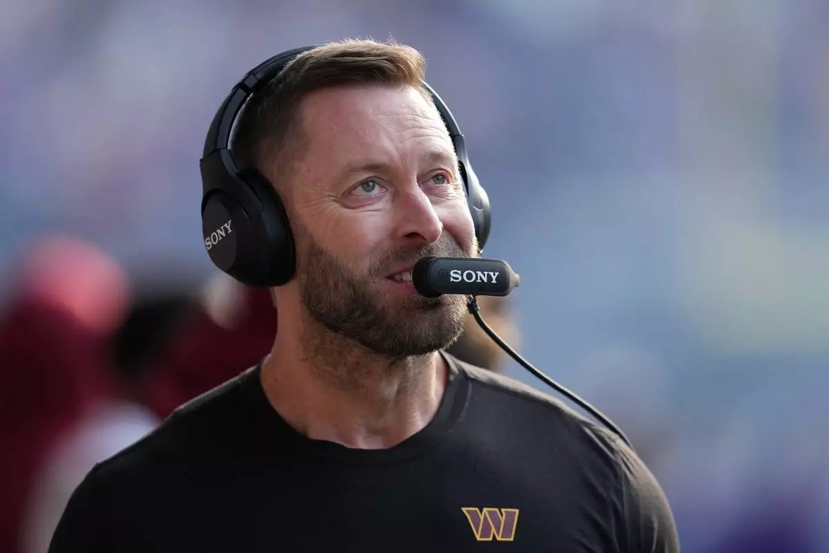 FILE - Washington Commanders offensive coordinator Kliff Kingsbury stands on the field before an NFL football game against the Minnesota Vikings, Dec. 7, 2025, in Minneapolis. (AP Photo/Abbie Parr, File)