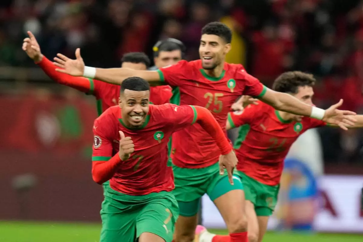 Morocco players celebrate after winning after a penalty shootout during the Africa Cup of Nations semi-final match between Nigeria and Morocco in Rabat, Morocco, Wednesday, Jan. 14, 2026. (AP Photo/Mosa'ab Elshamy)