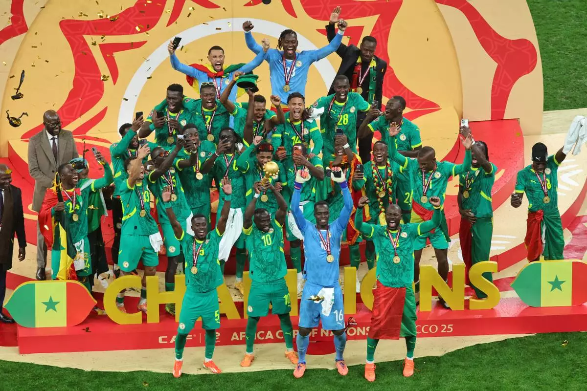 Senegal's Sadio Mane holds the trophy aloft as he celebrates with teammates after winning the Africa Cup of Nations final soccer match between Senegal and Morocco in Rabat, Morocco, Sunday, Jan. 18, 2026. (AP Photo/Youssef Loulidi)