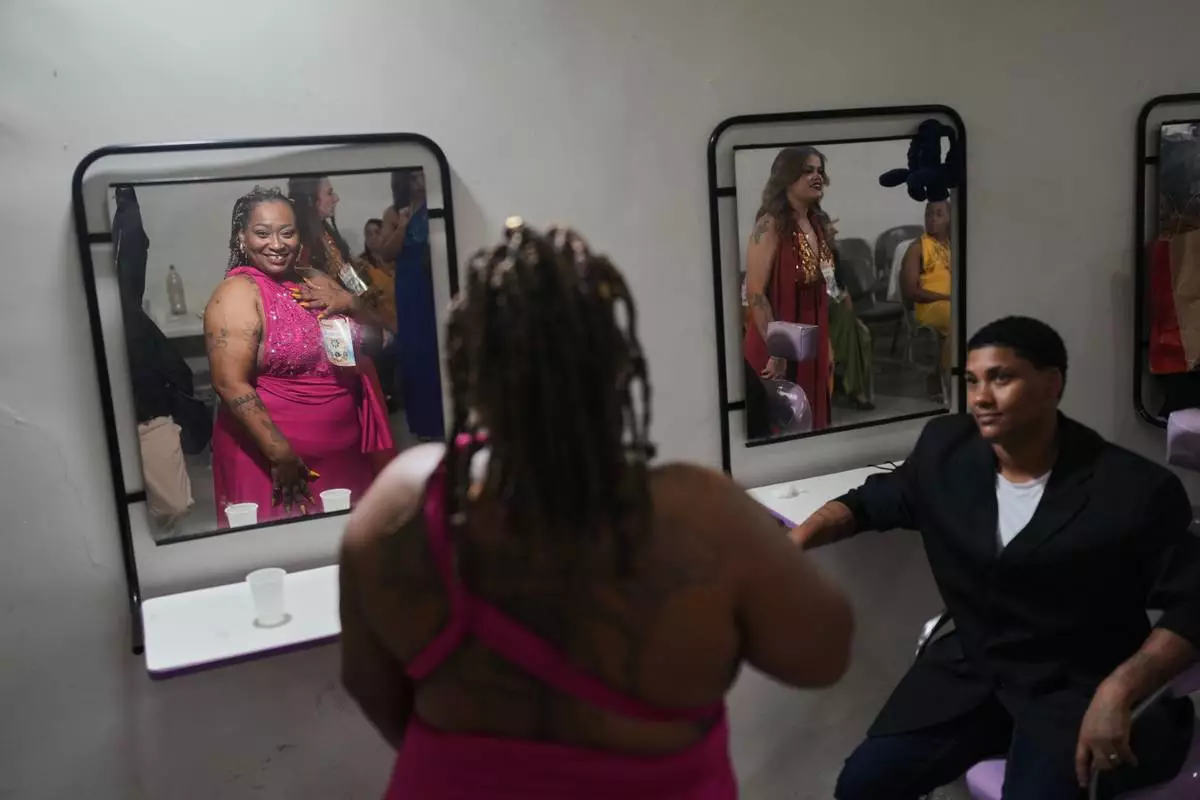 FILE - Inmates get ready backstage to sing in the Voice of Freedom rehabilitation program event at the Djanira Dolores de Oliveira women's penitentiary in Rio de Janeiro, Friday, Jan. 23, 2026. (AP Photo/Silvia Izquierdo, File)