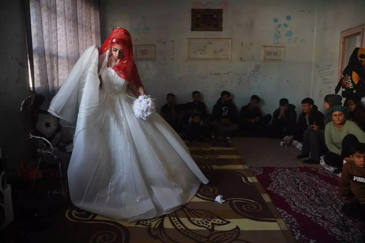 FILE - A Syrian bride displaced from the town of Al-Tabqa in northern Syria attends her wedding ceremony inside a classroom at a school being used as a shelter following clashes between Syrian government forces and the Kurdish-led Syrian Democratic Forces in Qamishli, northeastern Syria, Monday, Jan. 26, 2026. (AP Photo/Baderkhan Ahmad, File)