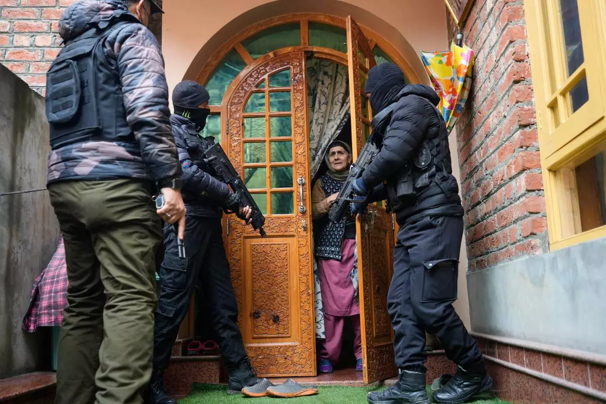 FILE - Jammu and Kashmir Special Operation Group (SOG) personnel question local residents during a house-to-house search operation as part of heightened security measures ahead of India's Republic Day in Srinagar, Indian controlled Kashmir, Sunday, Jan. 25, 2026. (AP Photo/Mukhtar Khan, File)