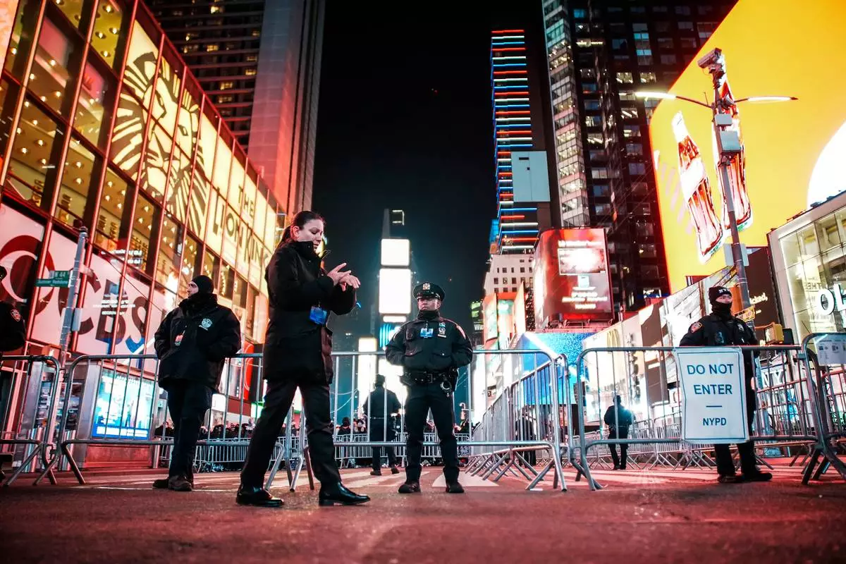 NYPD officers stand guard in Times Square during New Year's Eve celebrations, Wednesday, Dec. 31, 2025, in New York. (AP Photo/Eduardo Munoz Alvarez)