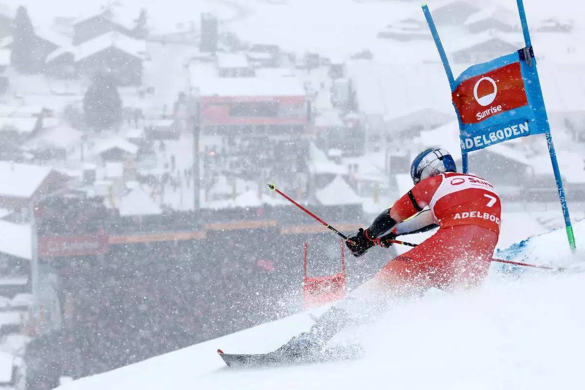 Switzerland's Marco Odermatt speeds down the course on his way to win an alpine ski, men's World Cup giant slalom, in Adelboden, Switzerland, Saturday, Jan. 10, 2026. (AP Photo/Gabriele Facciotti)