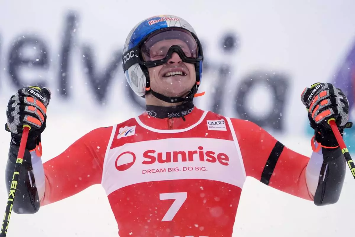 Switzerland's Marco Odermatt celebrates winning an alpine ski, men's World Cup giant slalom, in Adelboden, Switzerland, Saturday, Jan. 10, 2026. (AP Photo/Giovanni Zenoni)
