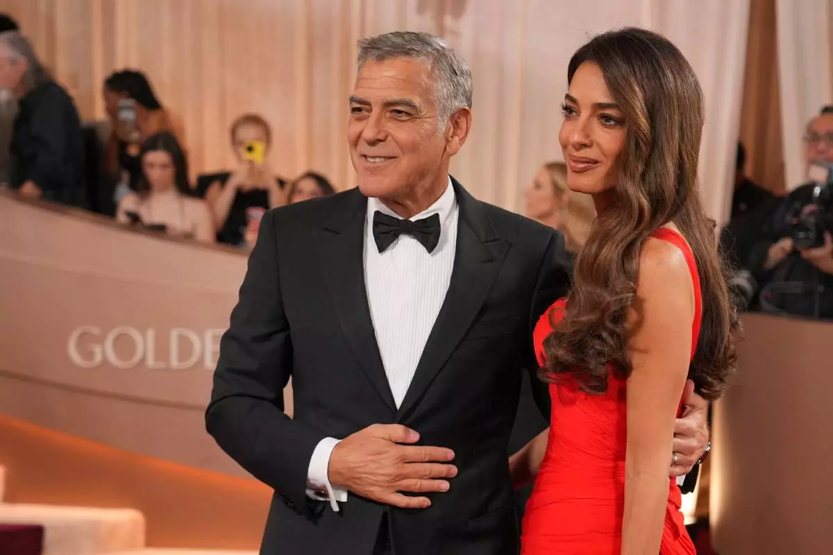 CORRECTS PERSONS PICTURED: George Clooney, left, and Amal Clooney arrive at the 83rd Golden Globes on Sunday, Jan. 11, 2026, at the Beverly Hilton in Beverly Hills, Calif. (Photo by Jordan Strauss/Invision/AP)