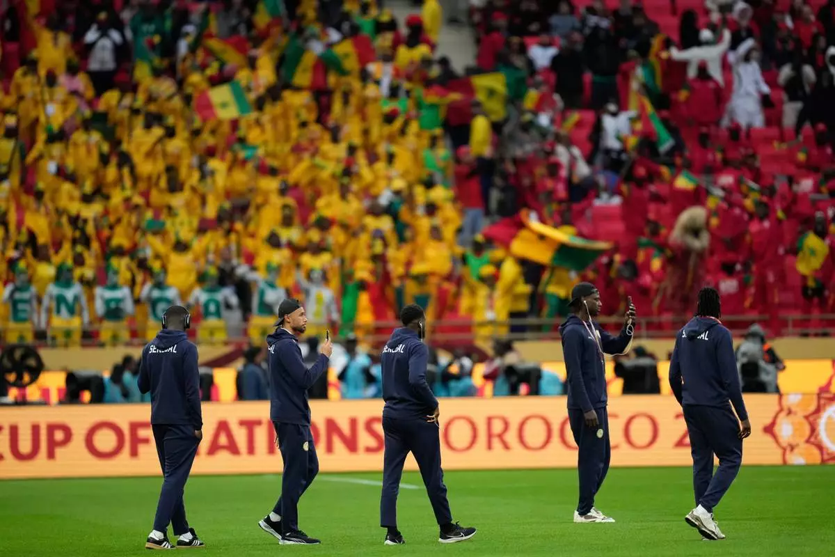 Senegal players walk onto the pitch before the Africa Cup of Nations final soccer match between Senegal and Morocco, in Rabat, Morocco, Sunday, Jan. 18, 2026. (AP Photo/Mosa'ab Elshamy)