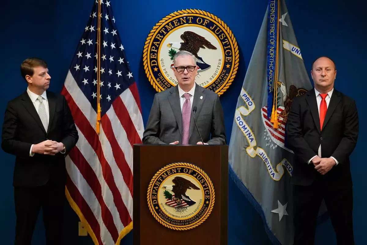 FBI Special Agent James C. Barnacle, Jr., center, U.S. Attorney for Western District of North Carolina Russ Ferguson, right, and Mint Hill Police Department Chief Joseph Hatley give a press conference, Friday, Jan. 2, 2026, in Charlotte, N.C. (AP Photo/Erik Verduzco)