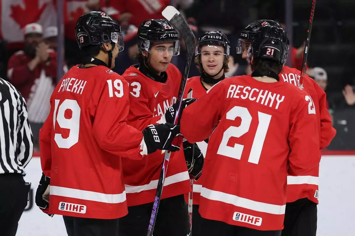Canada forward Sam O'Reilly (23) celebrates with teammates after a power play goal against Finland during the second period of an IIHF World Junior Hockey Championship bronze medal game, Monday, Jan. 5, 2026, in St. Paul, Minn. (AP Photo/Matt Krohn)