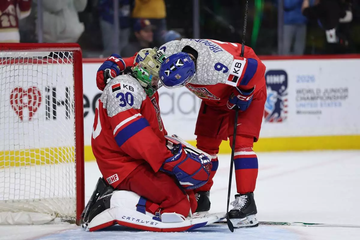 Czechia goalie Michal Orsulak (30) and defenseman Vladimir Dravecky (9) react after losing an IIHF World Junior Hockey Championship gold medal game to Sweden, Monday, Jan. 5, 2026, in St. Paul, Minn. (AP Photo/Matt Krohn)
