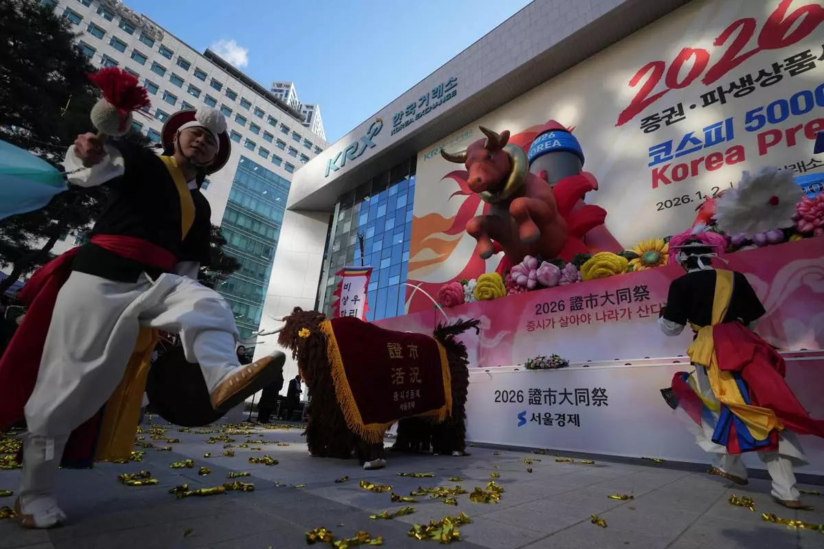 Dancers in traditional costumes perform to celebrate the opening for the 2026 trading year outside of the Korea Exchange in Seoul, South Korea, Friday, Jan. 2, 2026. (AP Photo/Lee Jin-man)