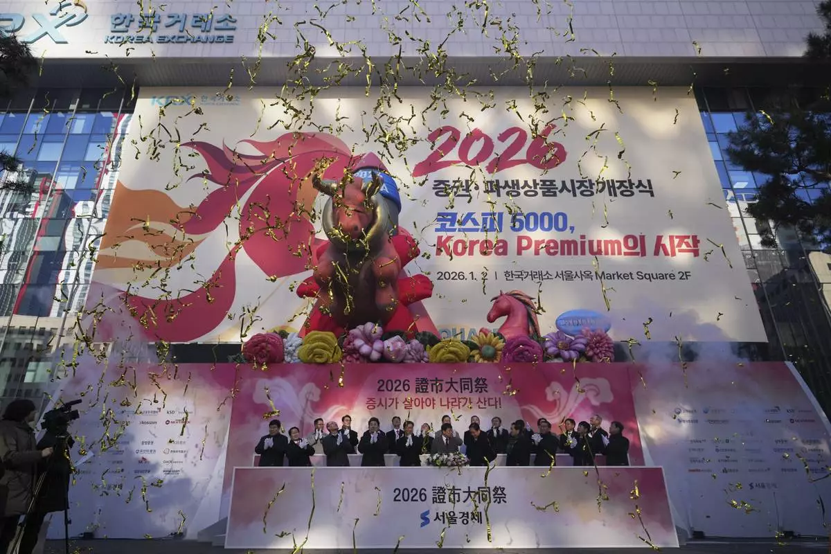 South Korean financial officers celebrate the opening for the 2026 trading year outside of the Korea Exchange in Seoul, South Korea, Friday, Jan. 2, 2026. (AP Photo/Lee Jin-man)