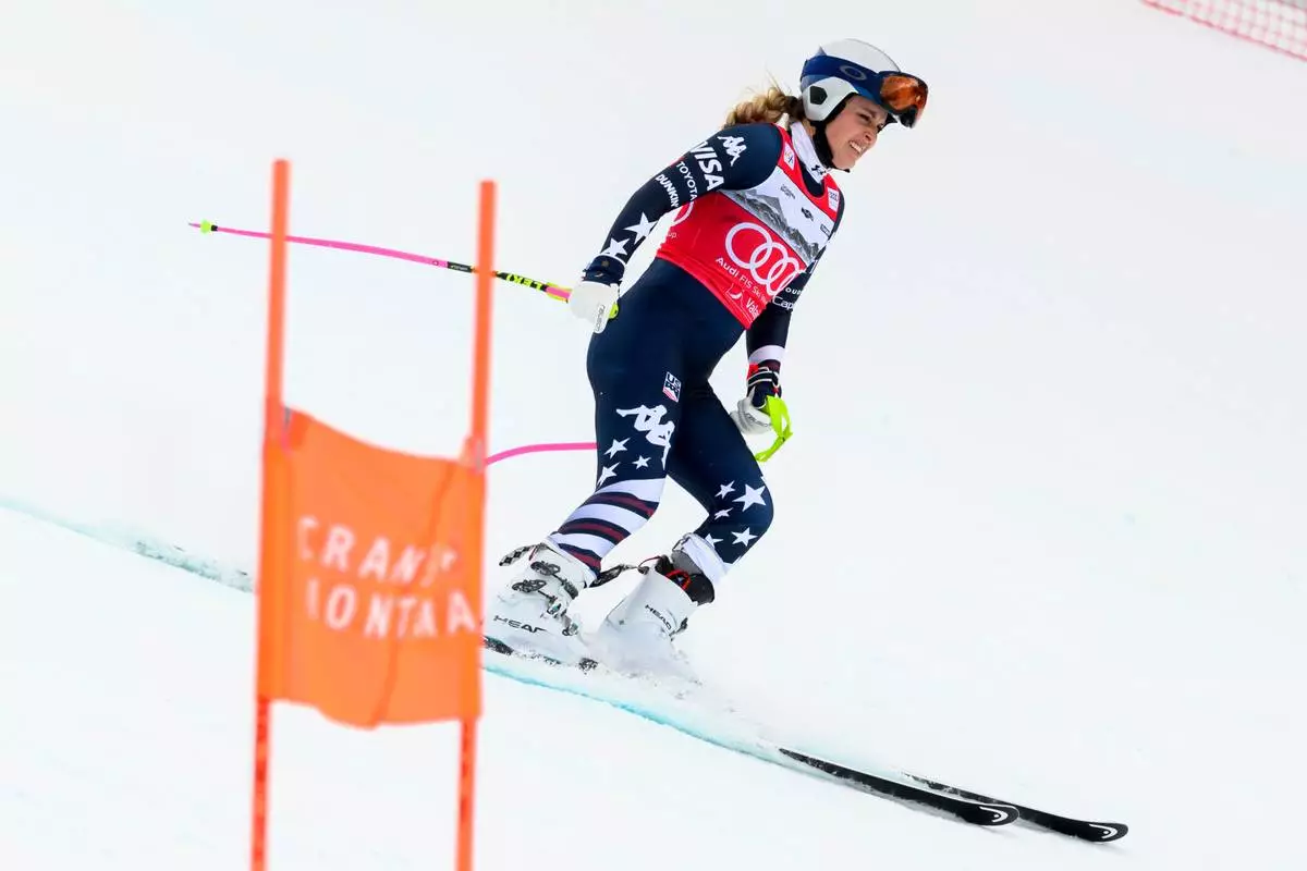 United States' Lindsey Vonn grimaces as she approaches the finish area after crashing, during an alpine ski, women’s World Cup downhill, in Crans Montana, Switzerland, Friday, Jan. 30, 2026. (Jean-Christophe Bott/Keystone via AP)