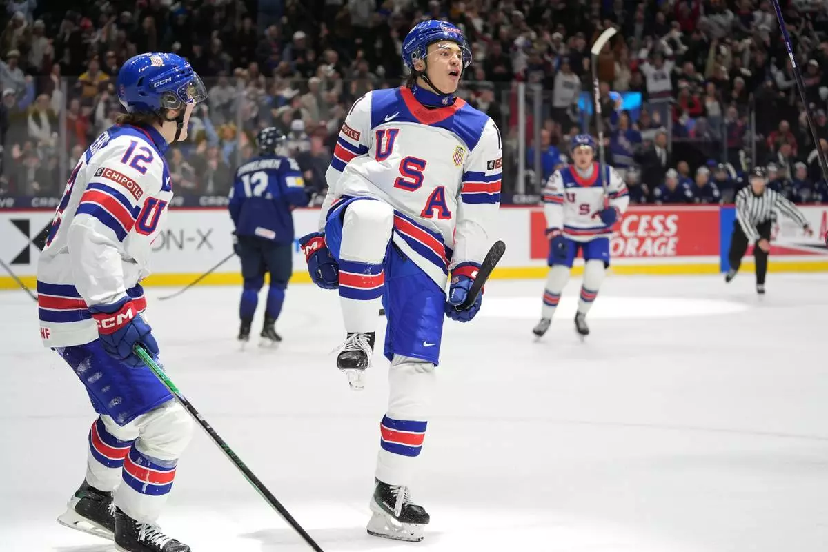 United States forward Ryker Lee, front right, celebrates after scoring during the third period of an IIHF World Junior Hockey Championship quarterfinals game against Finland, Friday, Jan. 2, 2026, in St. Paul, Minn. (AP Photo/Abbie Parr)