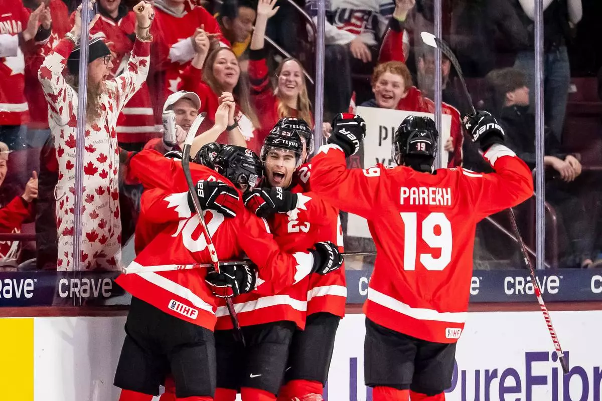 Canada's Cole Beaudoin (26) celebrates his goal with teammates after scoring in second period IIHF World Junior Championship hockey action against Finland in Minneapolis on Wednesday, Dec. 31, 2025. (Christopher Katsarov/The Canadian Press via AP)