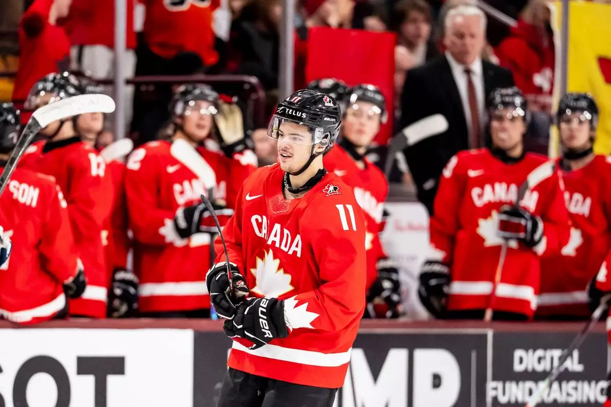 Canada's Tij Iginla (11) celebrates his goal with teammates after scoring in second period IIHF World Junior Championship hockey action against Finland in Minneapolis on Wednesday, Dec. 31, 2025. (Christopher Katsarov/The Canadian Press via AP)