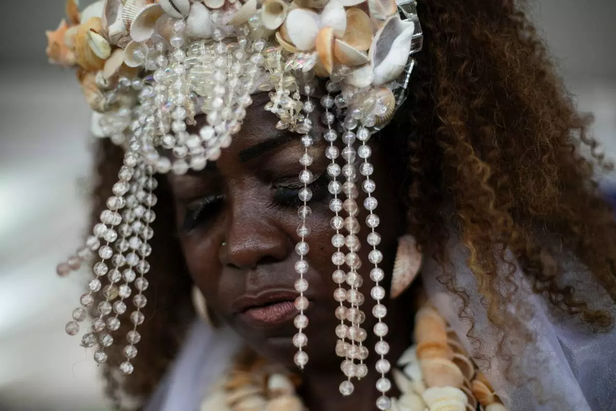 FILE - A devotee dances during a ceremony honoring Yemanja, the sea goddess of the Yoruba religion, on Copacabana Beach in Rio de Janeiro, Dec. 29, 2025. (AP Photo/Bruna Prado, File)