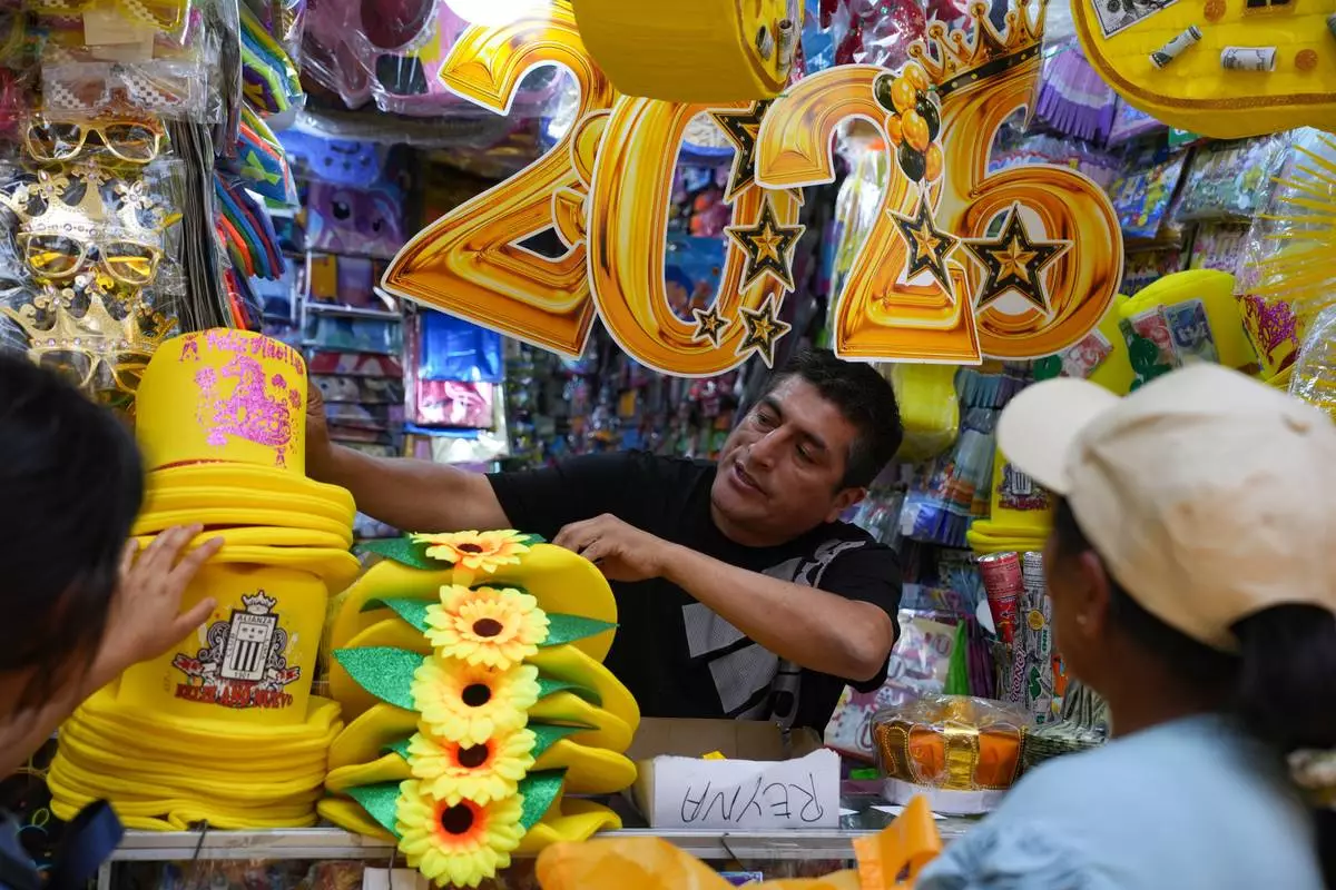 FILE - A vendor sells New Year's eve party goods at a market in downtown Lima, Peru, Dec. 30, 2025. (AP Photo/Guadalupe Pardo, File)